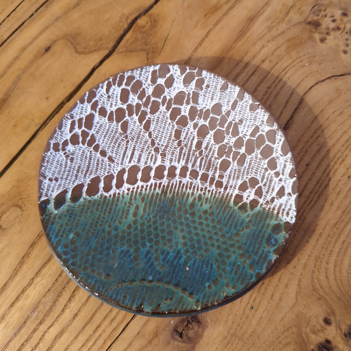White lace and blue glaze on red clay