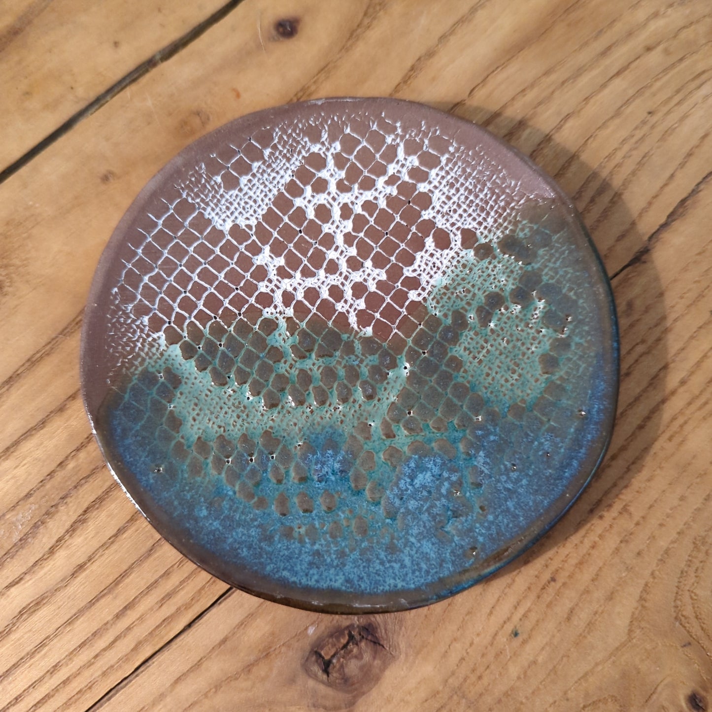 White lace and blue glaze on red clay