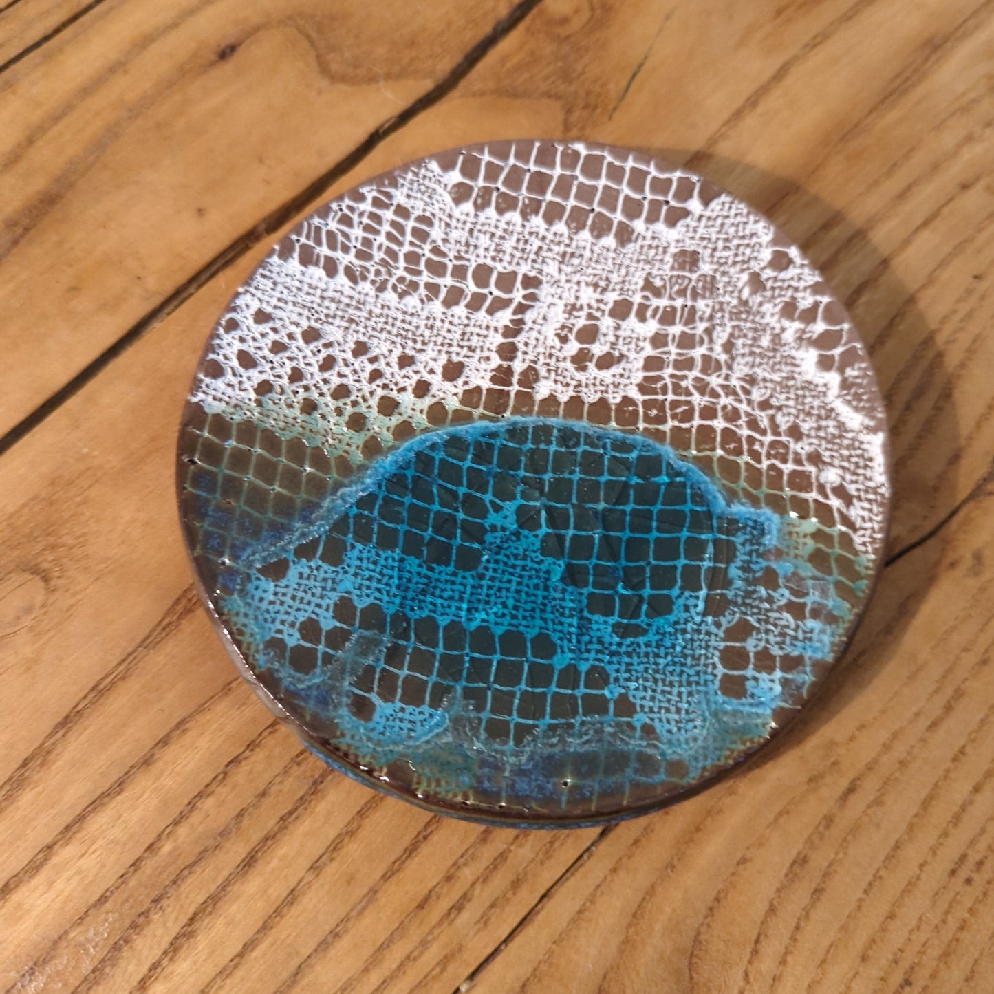 White lace and blue glaze on red clay