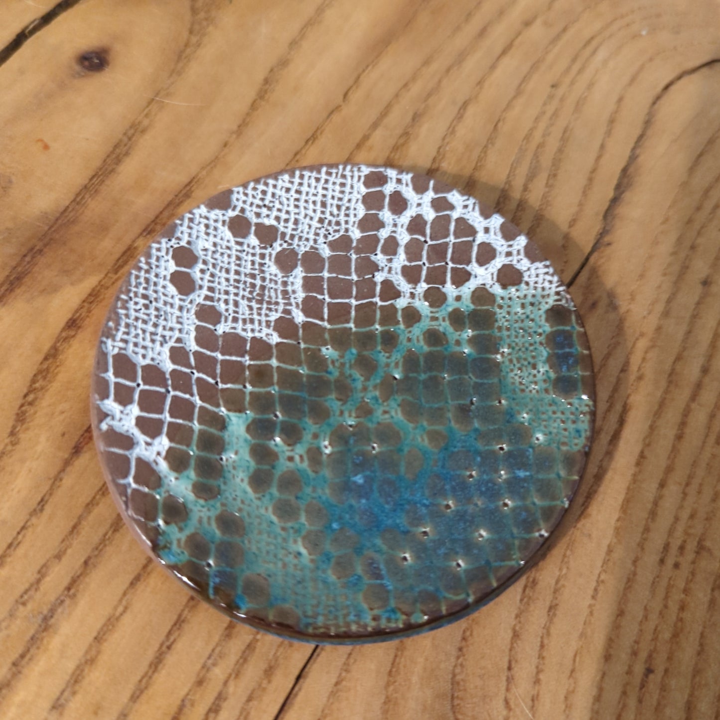 White lace and blue glaze on red clay