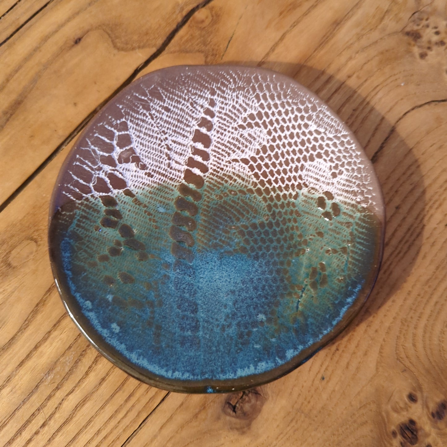 White lace and blue glaze on red clay
